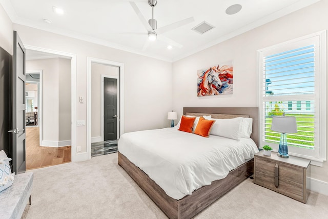 carpeted bedroom featuring ceiling fan and crown molding