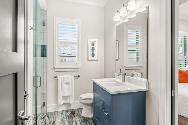 bathroom with walk in shower, wood-type flooring, vanity, and toilet