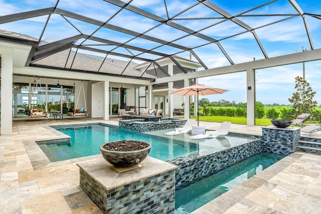 view of swimming pool featuring ceiling fan, a patio, glass enclosure, and an in ground hot tub