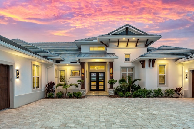 exterior entry at dusk with french doors