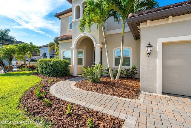 view of exterior entry featuring a garage