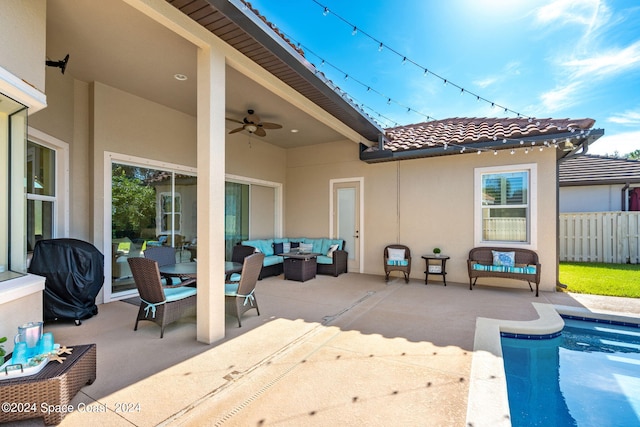 view of patio / terrace with outdoor lounge area, ceiling fan, and a fenced in pool