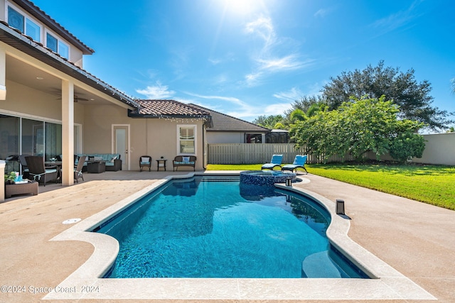 view of swimming pool featuring a lawn, a patio, ceiling fan, and outdoor lounge area