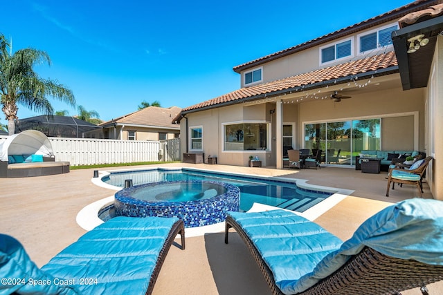 view of swimming pool with a patio, glass enclosure, an in ground hot tub, outdoor lounge area, and ceiling fan