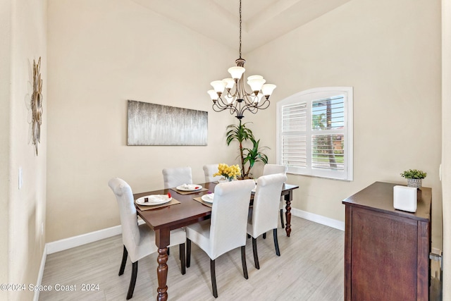 dining room featuring light wood-type flooring and a chandelier