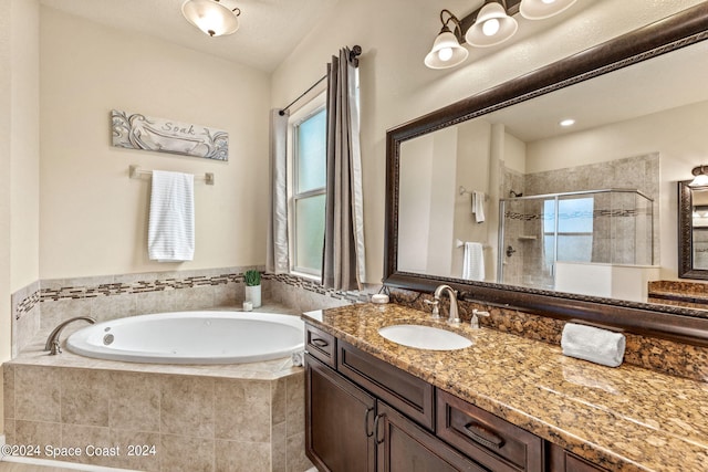 bathroom featuring vanity and plus walk in shower