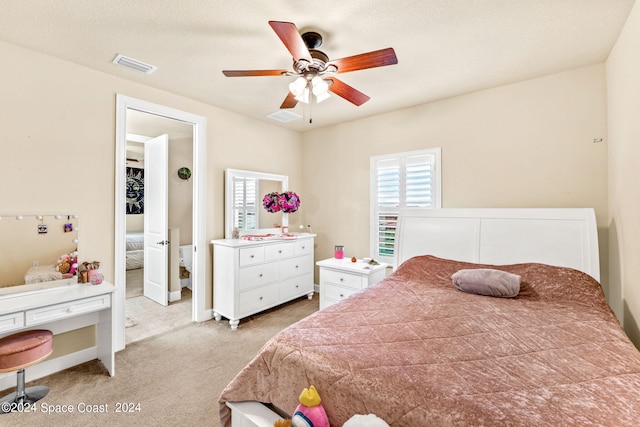 carpeted bedroom with a textured ceiling and ceiling fan