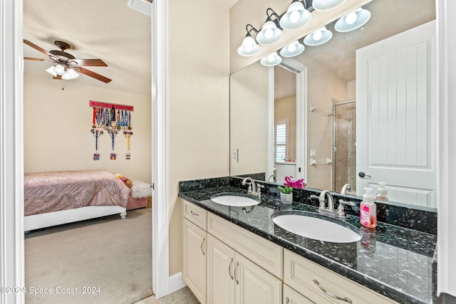 bathroom featuring vanity, ceiling fan, and a shower with shower door