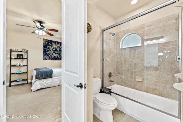 bathroom featuring ceiling fan, enclosed tub / shower combo, and toilet