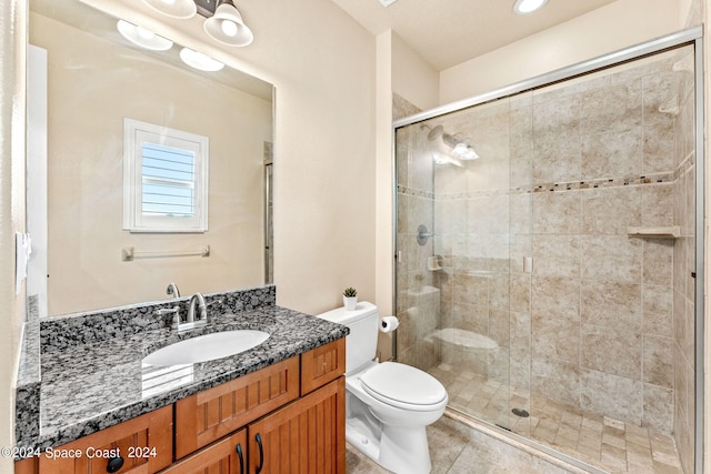 bathroom featuring walk in shower, vanity, toilet, and tile patterned floors