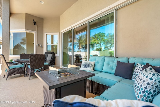 view of patio / terrace with an outdoor living space with a fire pit