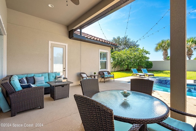 view of patio / terrace with a fenced in pool and outdoor lounge area