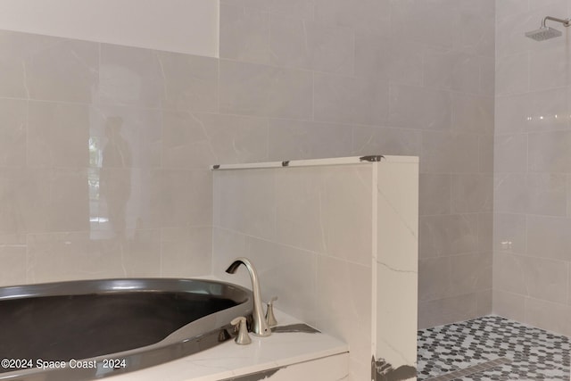 bathroom with tile walls and tiled shower