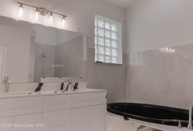 bathroom with tiled bath and vanity