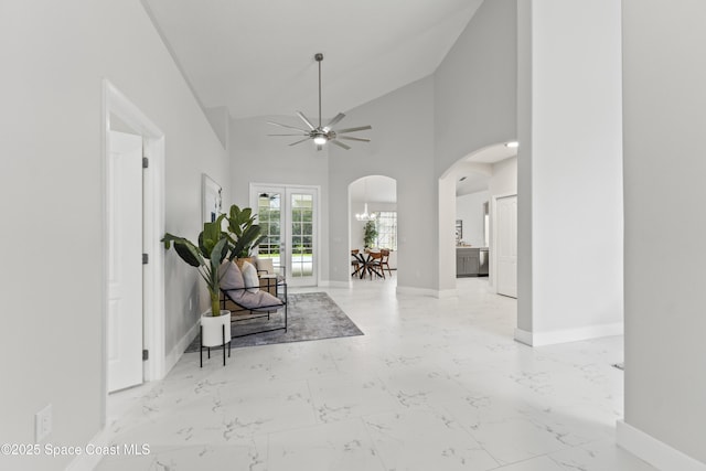 3520 Shady Run Rd, Melbourne, FL 32934 - sitting room featuring arched walkways, ceiling fan, baseboards, vaulted ceiling, and marble finish flooring