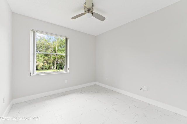 3520 Shady Run Rd, Melbourne, FL 32934 - unfurnished room with marble look tiles, baseboards, and a ceiling fan