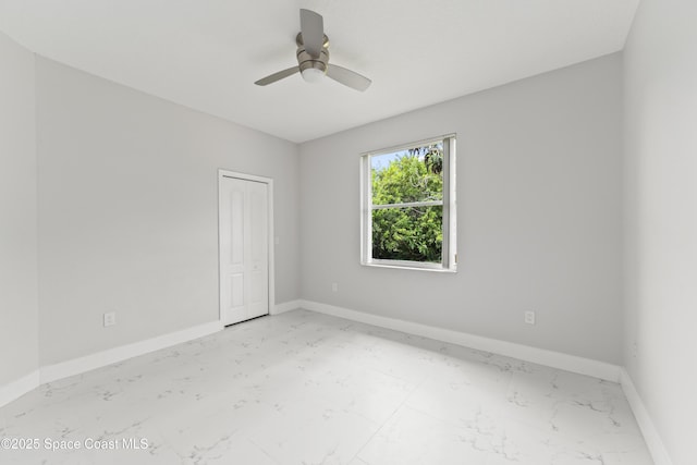 3520 Shady Run Rd, Melbourne, FL 32934 - spare room featuring light marble finish floors, ceiling fan, and baseboards