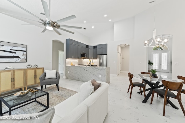 3520 Shady Run Rd, Melbourne, FL 32934 - living room with arched walkways, a chandelier, light marble finish floors, ceiling fan, and recessed lighting