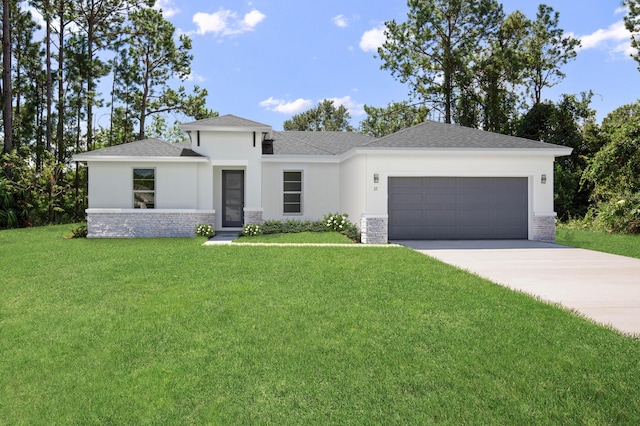 prairie-style house featuring a garage and a front yard