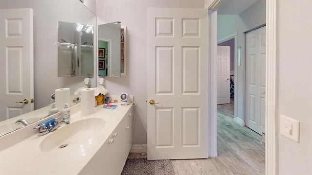 bathroom with vanity and wood-type flooring