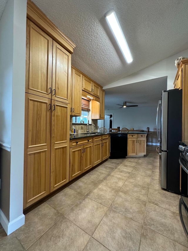 kitchen featuring ceiling fan, a textured ceiling, dishwasher, and light tile patterned floors