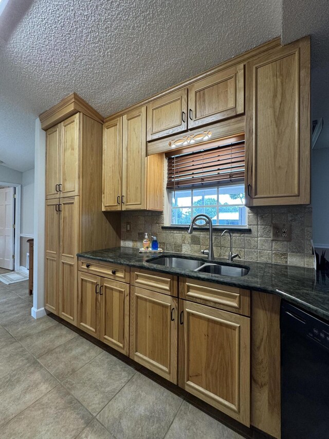 kitchen with sink, dishwasher, a textured ceiling, and backsplash