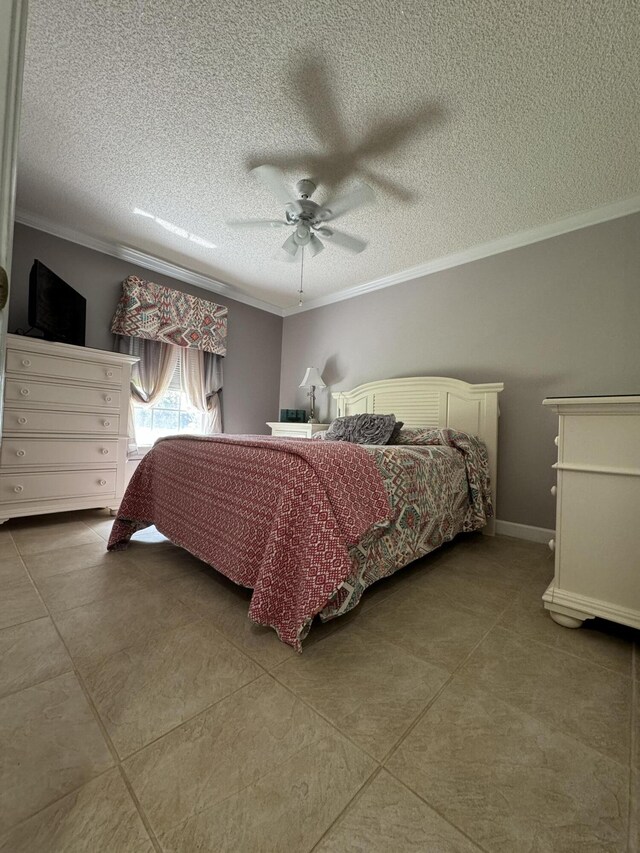 tiled bedroom featuring ceiling fan, ornamental molding, and a textured ceiling