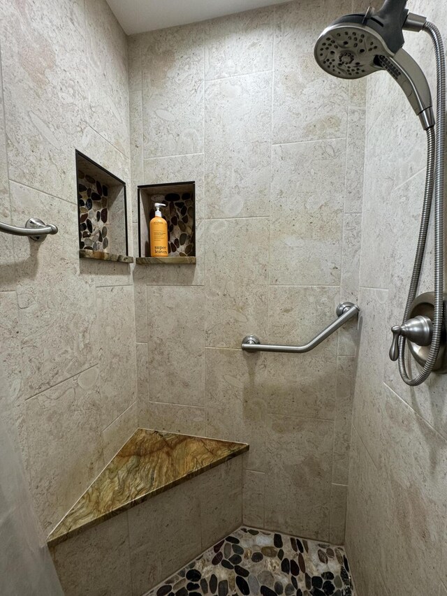 bathroom with a tile shower