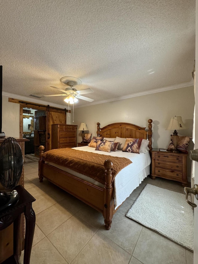 tiled bedroom featuring ceiling fan, a textured ceiling, crown molding, and a barn door