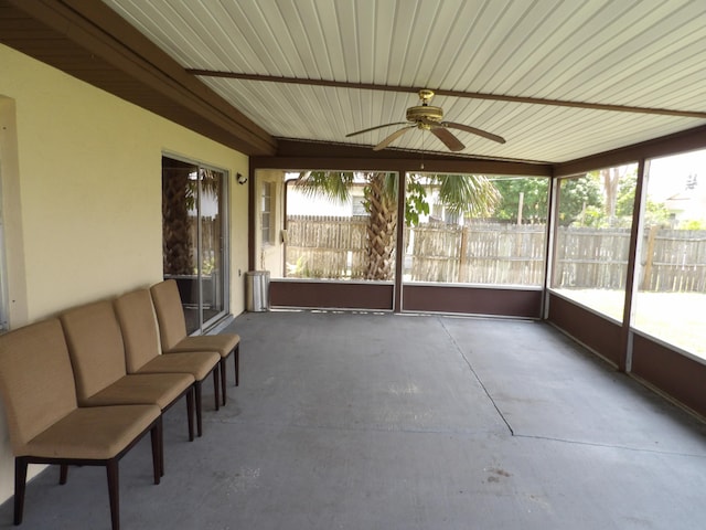 unfurnished sunroom featuring ceiling fan