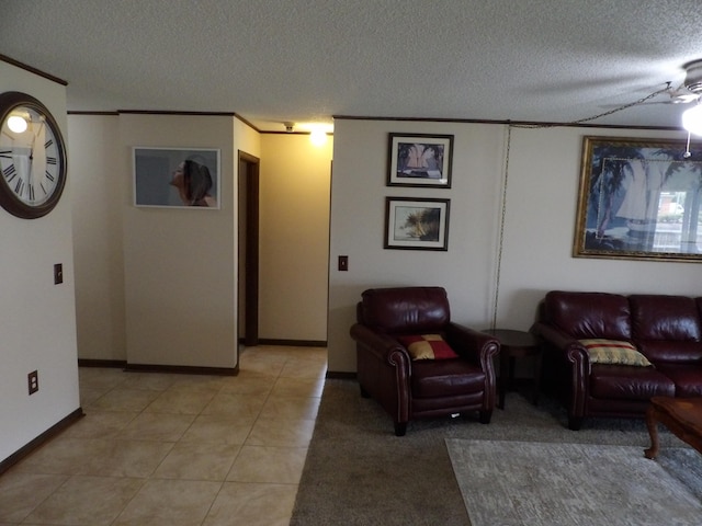 tiled living room featuring ceiling fan, crown molding, and a textured ceiling