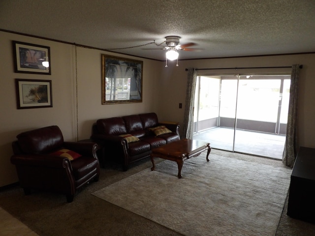 living room featuring ceiling fan, a textured ceiling, and carpet floors