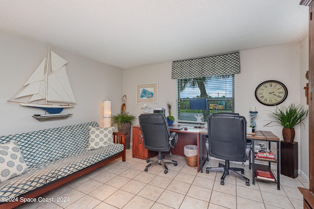 office area featuring light tile patterned floors and a textured ceiling