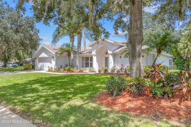 view of front of house featuring a garage and a front lawn