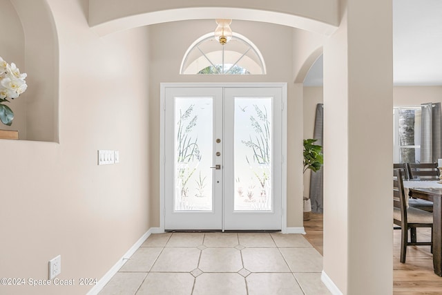 entryway with light hardwood / wood-style flooring and french doors