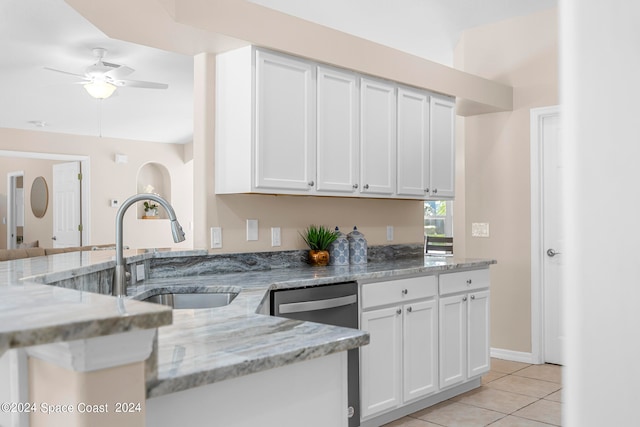 kitchen featuring ceiling fan, white cabinetry, light tile patterned flooring, and light stone counters