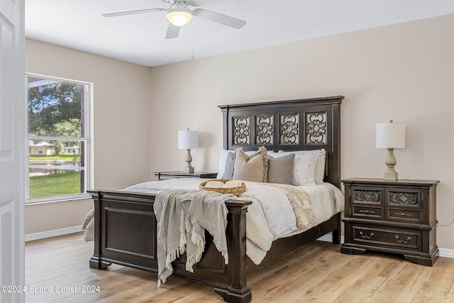 bedroom with ceiling fan and light hardwood / wood-style floors