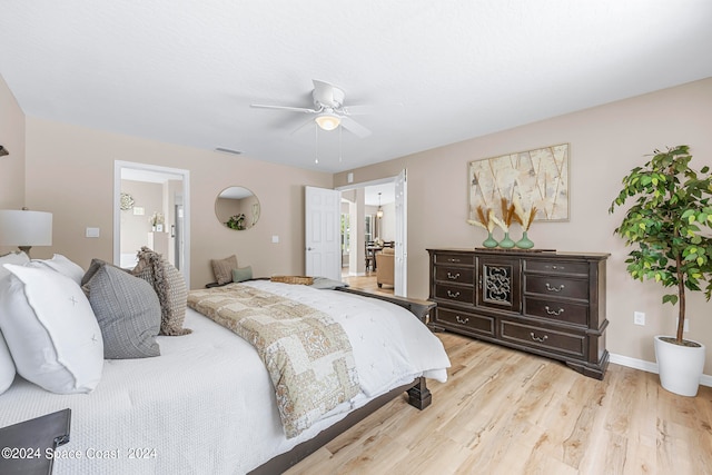 bedroom featuring ceiling fan, connected bathroom, and light hardwood / wood-style floors