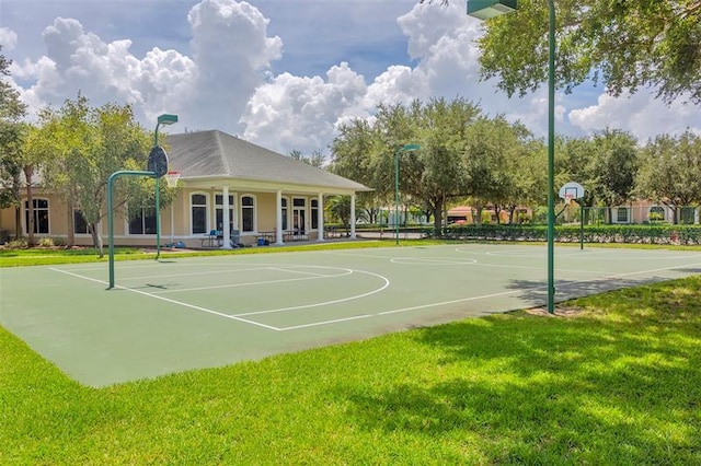 view of sport court with a yard