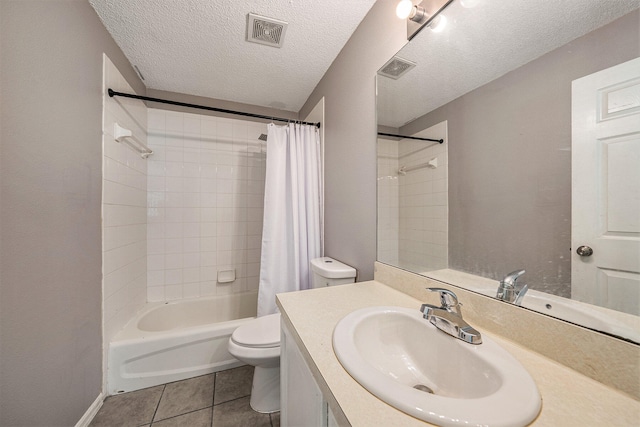 full bathroom featuring shower / tub combo, a textured ceiling, toilet, tile patterned flooring, and vanity