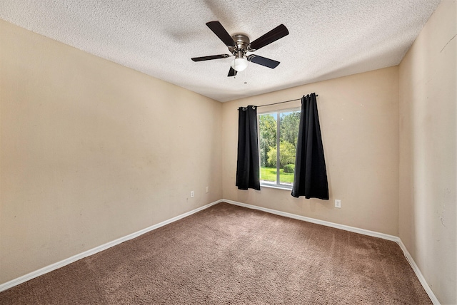 empty room with a textured ceiling, ceiling fan, and carpet floors