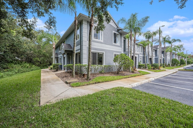 view of property exterior with a lawn