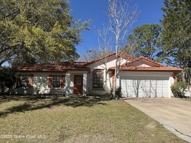 view of front facade with a tile roof, a front yard, stucco siding, a garage, and driveway