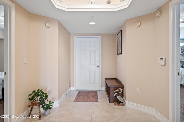 doorway with light tile patterned flooring and a skylight