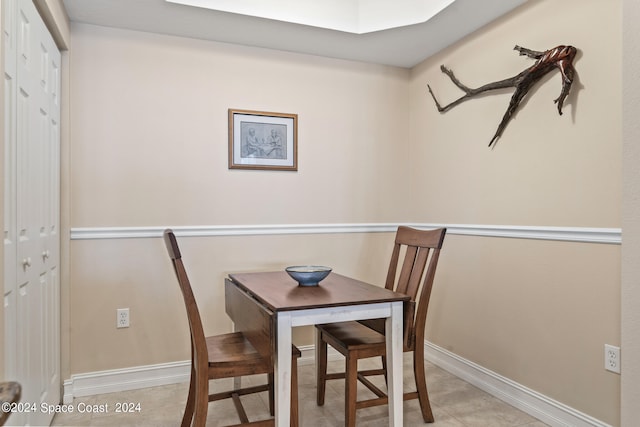 dining area featuring light tile patterned flooring