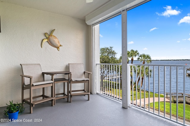 sunroom / solarium featuring a water view