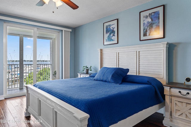 bedroom featuring dark hardwood / wood-style floors, a textured ceiling, access to exterior, and ceiling fan