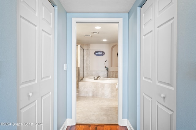 corridor featuring hardwood / wood-style flooring