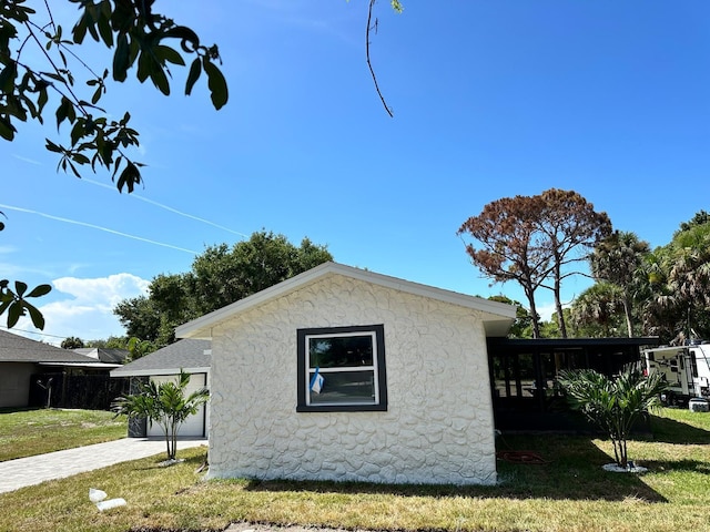 view of side of home featuring a yard