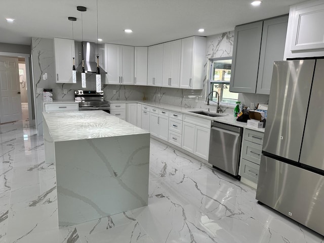 kitchen featuring stainless steel appliances, a kitchen island, sink, light tile patterned flooring, and wall chimney range hood